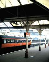 The previous canopy 'glazing' at Kilmarnock was corrugated fibreglass which became steadily more grimy and by the time it was due for replacement it was almost opaque. When this picture of the bay platforms was taken in August 1985 it still had many more years to go. Compare this with the station in 2010 [see image 30172], after reglazing with proper glass and at least two repaintings of the ironwork. <br>
<br><br>[David Panton /08/1985]