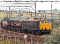 E26031, still in green livery, approaches Wombwell Main Junction from the west with empty coal hoppers in the summer of 1971. The train is returning to the South Yorkshire coalfield to collect another load.<br><br>[Bill Jamieson 21/07/1971]