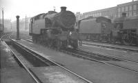 Shed scene at Accrington (24A) on 25 September 1960 looking east with Charter Street on the right. The shed was located on the East Lancs between the stations of Church & Oswaldtwistle (behind camera) and Accrington. Closed to steam in March 1961, the shed saw some further use as a DMU servicing depot. It was eventually demolished in the 1970s and housing now occupies the site.<br><br>[K A Gray 25/09/1960]