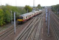 Rutherglen Central Junction is where the Argyle Line, left, meets the<br>
main lines from Glasgow Central. 318 256 has left Rutherglen station (behind the camera) and is joining the Up Slow line to allow at Virgin service on the Up Main (second from right) to pass before itself joining the WCML at Rutherglen East. After Rutherglen East the overhead wires on the slow line disappear as it becomes the Whifflet line. <br><br>[David Panton 16/10/2010]