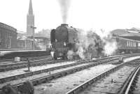 A1 Pacific no 60141 Abbotsford takes a southbound train out of a snow covered Newcastle Central in the 1960s.<br><br>[K A Gray //]