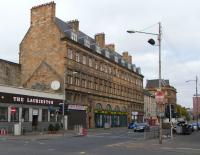 I'm standing south of the Clyde, a few hundred yards short of Glasgow Central; the running lines are behind that wall. The original Bridge Street terminus was to the right of all the building on the opposite side of the street. This station which predated Glasgow Central and the bridging of the Clyde. The original building's much larger extension has survived and dominates the picture. It had quite a short working life, closing in 1905 after Glasgow Central and its approaches were enlarged to accommodate all services. The upper storeys are occupied by flats, and windows at the back offer in-your-face rail comings and goings. The accompanying sounds must be a mixed blessing (or perhaps an unmixed curse) to residents for whom a train is a train.<br><br>[David Panton 16/10/2010]