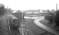 The 2.17pm departure from Peebles passes Peebles goods yard en route to Galashiels on 3 February 1962, the final day of passenger services over the line. At the south end of the yard, just beyond the signal box, an NBR chord line (closed 1959) curved away from Peebles Junction on the left to the right, crossing the Tweed to link up with the Caledonian Railway terminus south of the river [see image 29949]. <br>
<br><br>[Frank Spaven Collection (Courtesy David Spaven) 03/02/1962]