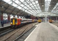 Just about to start its 5 hour 20 minute journey, on the 12.52hrs through service to Norwich, this Stagecoach liveried 158 at Lime St station makes a colourful contrast to the Northern units in their purple and mauve scheme. Left to right the trains are: 158770 for Norwich, 142053 for Manchester Victoria, 156482 for Blackpool and 150228 newly arrived. <br><br>[Mark Bartlett 21/10/2010]