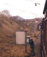 The fireman carries out Rule 55 after this westbound branch train was held at Kelso Junction en route to St Boswells in April 1962. The Eildon Hills can just be glimpsed in the distance.<br><br>[Frank Spaven Collection (Courtesy David Spaven) /04/1962]