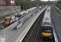 Springburn Station seen on 16 October with a recently arrived 334 013 at Platform 3 and 170 411 about to leave on the final leg of a Cumbernauld to Queen Street service at Platform 1.  The only point of similarity with a similar view taken in 1954 [see image 7156] is the platform arrangement.  <br><br>[David Panton 16/10/2010]