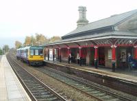 Earlestown was built in 1835 and apparently is the oldest railway station building in the world that has survived on an operational passenger station. 142003, on a Manchester Liverpool service, draws up alongside the very ornate platform canopy. Although the station is still staffed this building is not currently in use. Behind it is the platform reopened for use by Liverpool Warrington services [See image 31359] making Earlestown a full <I>triangle</I> station again. View towards Newton-le-Willows and Manchester along the original Liverpool and Manchester line of 1830.<br><br>[Mark Bartlett 04/11/2010]