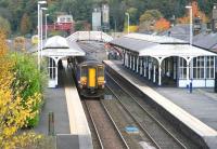 Autumn colours abound at Hexham on 1 November 2010 as the 15.22 Carlisle - Middlesbrough train prepares to leave the eastbound platform.<br><br>[John Furnevel 01/11/2010]