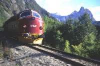 No, not America in the 1950s - Norway in 1995! Heading a westbound passenger service, Di3 No 3632 drifts down the gradient towards the Andalsnes terminus of the scenically dramatic 71-mile 'branch line' from Dombas. Between 1954 and 1969 - under licence from the EMD division of General Motors in the USA - the Trollhattan (Sweden) NOHAB works built 31 of these 1,775hp Di3s for Norwegian State Railways.<br><br>[Frank Spaven Collection (Courtesy David Spaven) //1995]