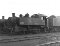 USA 0-6-0T no DS233 (formerly 30061) stands on Eastleigh shed in April 1967 carrying its departmental number along with the words 'Engineers Dept.' Following many years working at Southampton Docks, 30061 was one of 6 of the class renumbered and reallocated to departmental duties, in this case at Redbridge sleeper depot. The locomotive is seen here following final withdrawal awaiting disposal, which occurred 3 months later via Messrs Cashmore, Newport.<br><br>[David Pesterfield 22/04/1967]