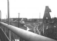 View over the site of Patricroft MPD (latterly 9H) in 1968, the year of official closure with a few steam and diesel locomotives on shed. This was a large depot, with what was the original 8 road straight shed on the left eventually forming an 'L' shape with the later 10 road shed standing beyond the coaling plant. Patricroft was demolished in August 1968, a few weeks after closure.  <br><br>[Jim Peebles //1968]