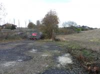 The product of the late-Victorian Binnend Oilworks was sent off on its two mile branch to join the network immediately north of Kinghorn station. Some of it however didn't get that far as there was a candle factory on the branch. The building survived until recently. This is the site of it looking east on 6 November. The line curved round to the right, where that fence now is, and passed where I'm standing.You'll have to imagine the walrus moustaches, gormless expressions and total disregard for health and safety.<br>
<br><br>[David Panton 06/11/2010]