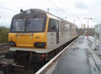 92042 <I>Honegger</I> lays over between duties in the short bay at the south end of Bank Quay's island platform. Immediately beyond the platforms is the entrance to the Arpley Yard complex on the east side of the WCML. The locomotive still has the Eurotunnel cast emblems on its flanks but also a large EWS crest. <br>
Footnote: Apparently Arthur Honegger, a Swiss composer, was also a railway enthusiast and his most famous piece of music was entitled Pacific 2-3-1 (axles rather than wheels in European designations).  <br><br>[Mark Bartlett 04/11/2010]