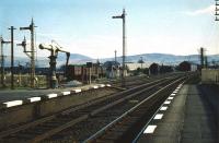 Platform view south along the WCML at Symington in April 1959. The former Caledonian route to Peebles ran east from here, although by this time it had been cut back to Broughton. Goods traffic for the latter can be seen on the up side of the main line. Symington station lost its pasenger service in 1965 with the line to Broughton closing a year later.<br><br>[A Snapper (Courtesy Bruce McCartney) 04/04/1959]