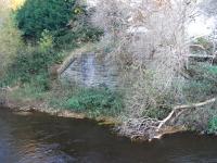 The goods line which left the NBR North Leith branch just to the east of Bonnington station was many branched, but it crossed the Water of Leith only once. The southern abutment of the bridge is seen here on 13 November. Nearby is a lifelike statue of a naked man standing in the river. It was rather unnerving being alone with him, particularly as he was clearly not feeling the cold.<br>
<br><br>[David Panton 13/11/2010]