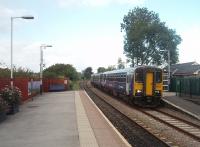 A capacity boost for the 1640 Clitheroe to Manchester Victoria as <I>Bubble Car</I> 153382 waits with 156482 for departure. The large building just visible beyond the trees is the Ribble Cement works at Horrocksford [See image 9868].<br><br>[Mark Bartlett 16/09/2010]