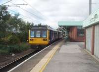 Platform 5 at Wigan North Western, a loop on the west side of the station, sees 142012 newly arrived on an all stations service from Liverpool via St. Helens Central and about to return to Lime Street by the same route. <br><br>[Mark Bartlett 21/10/2010]