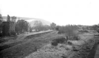 The large yard area and former grand Caledonian station building at Peebles on a dull day in February 1962.  This was eight years after complete closure and 12 years since the last passenger train had called. View is east towards the Tweed Bridge, part of which can be seen in the left background just beyond the station.<br><br>[Frank Spaven Collection (Courtesy David Spaven) 03/02/1962]