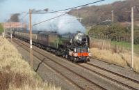 A1 60163 <I>Tornado</I> heads for Euston from Edinburgh, on a glorious autumn afternoon, with Day 3 of the Christmas Coronation railtour. The loco was running with <I>The Cathedrals Express</I> headboard and is seen at Woodacre, on the racing ground between Lancaster and Preston, with the M6 Motorway behind and the Grizedale Beck in between. Unfortunately, 60163 had to be assisted by a Class 66 diesel on the last leg from Rugby to Euston due to poor coal affecting its steaming.  <br><br>[Mark Bartlett 20/11/2010]