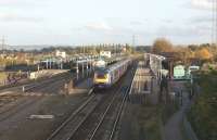 A scene of considerable activity at Didcot station on Saturday 30 October 2010. From left to right there are FGW Turbostars at platforms 5 and 4; a Cross Country service has just departed east from platform 3 towards Reading with a service to Bournemouth, while a FGW HST is arriving from the west at platform 2. The increased activity is due to closure of the line towards Oxford for engineering work and the need for rail replacement buses, two of which can be seen in the car park on the right.<br>
<br>
<br><br>[John McIntyre 30/10/2010]