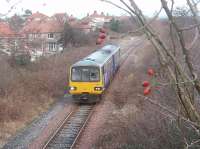 The Heysham Boat Train ambles down the branch to the Port. 144013 is allowed 15 minutes for the four mile journey from Morecambe so, even with the manual points change at the junction [See image 18085] the pace is leisurely. This picture was taken looking north from Regent Rd bridge. <br><br>[Mark Bartlett 22/11/2010]