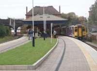 The view along what remains of the island platform at Poulton-le-Fylde as 158755 calls on a Blackpool North to York service. The junction semaphore is also 'off' for the Blackpool line, with the signalbox visible under the bridge, but the enthusiasts on the platform are not stirring as <I>Leander</I> is not due yet [See image 30890].<br><br>[Mark Bartlett 02/10/2010]