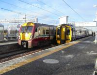 On 24 November a westbound 6-car 334 makes a stop on a training run <br>
passing 158729 at Platform 1 waiting to return to Edinburgh. The new ScotRail depot stands in the background. In the nicest possible way Bathgate will hope never to see a 158 again come 12 December.<br>
<br><br>[David Panton 24/11/2010]