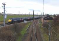 Probably like everyone else who has stood on this bridge over the start of the North Berwick branch I wish it were a little nearer the <br>
junction. However, make the best of it. An East Coast 225 cuts through the flat countryside of northern East Lothian with a King's Cross service on 13 November.<br>
<br><br>[David Panton 13/11/2010]