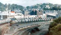 Busy scene at Oban in the summer of 1983, with a large number of oil tanks in the sidings, as well as a Class 37 and coaches. M.V. <I>Columba</I> is berthed at the pier.<br>
<br><br>[Colin Miller /07/1983]