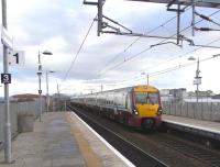 334s are associated so much with Glasgow that it's odd to see one <br>
within sight of of Arthur's Seat, though I'm sure we'll soon get used to it. A 6-car set passes west through Edinburgh Park station on a training run on 24 November.<br><br>[David Panton 24/11/2010]