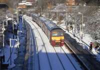 320 312 pulls into a snowy Alexandra Parade station on 27 November with a Springburn to Dalmuir service. <br>
<br><br>[David Panton 27/11/2010]