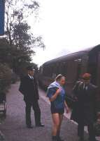 The guard of a Ballachulish-bound train watches passengers disperse at Ballachulish Ferry station, thought to be in the summer of 1965, with the mountains of Glencoe in the distance. The station closed along with the rest of the branch in March 1966. <br><br>[Frank Spaven Collection (Courtesy David Spaven) //1965]