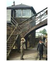 Smartly turned out to the end. Coldstream's Stationmaster checks train doors on the final eastbound passenger service, the 4.2 pm from St Boswells to Berwick on 13th June 1964. Freight services from Kelso to Tweedmouth continued to pass through Coldstream for a further nine months, then lingered on west of Kelso to St Boswells until April 1968.<br><br>[Frank Spaven Collection (Courtesy David Spaven) 13/06/1964]