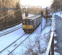 314 211 approaches Mount Florida station heading for Glasgow Central on 27 November. High retaining walls are a feature of this part of the Cathcart Circle, giving a hemmed-in feel. <br>
<br><br>[David Panton 27/11/2010]