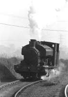 Scene at Niddrie towards the end of 1970 as NCB Lothians North no 25 (AB 2358 of 1954) heads back from the exchange sidings at Niddrie West to the shed near Newcraighall Road. [see image 1071]<br><br>[John Furnevel 30/11/1970]