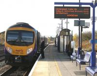 A cheery smile for the photographer as the 10.47 Scarborough - Liverpool Lime Street TransPennine service makes the first stop on its coast-to-coast journey at Seamer on 16 October 2009. The feathered junction signal in the background marks the divergence of the Yorkshire coast line to Hull.<br><br>[John Furnevel 16/10/2009]