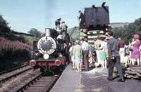 Rudimentary watering facilities at Oxenhope for the newly reopened Worth Valley Railway. USA 0-6-0T 30072 takes on water surrounded by onlookers and cameras. <br><br>[David Hindle //1969]