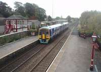 Looking towards Skipton from the Settle footbridge as 158907 leaves on a Carlisle to Leeds train. Unit 158907, displaying an unusual livery on its skirting, is passing the preserved signal box.<br><br>[Mark Bartlett 23/10/2010]