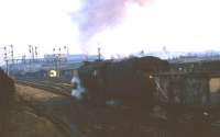 Last duties for a Stanier 5MT 4-6-0 in 1968 as it heads east with a rake of 16T coal empties at Bolton Junction, just outside Blackburn station. The large gantry of semaphores controlling the junction had only another four years of service too before Preston power box took control of the line. However, the goods yard on the right still sees rail borne traffic to this day and the small cabin under the gantry has also survived. <br><br>[David Hindle //1968]