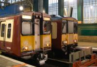 Ice to meet you! Snow covered 314208 and 318255 stand at platforms 14 and 15 at Glasgow Central station on 6th December 2010.<br><br>[Graham Morgan 06/12/2010]