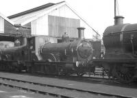 Locomotives on shed at Eastleigh in October 1962, featuring 2-4-0WT no 30587, one of the famous Southern Railway well tanks designed by Joseph Beattie. Built in 1874 by Beyer Peacock, at their Gorton Works in Manchester (at a cost of £2,570) no 30587 was withdrawn by BR in December 1962. The locomotive now forms part of the national collection [see image 22748] and can be seen operating on the Bodmin and Wenford Railway wher e it is on extended loan from the NRM.<br>
<br><br>[K A Gray 30/10/1962]