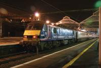 Scene at Preston station on 10 Dec 2010, the last night that 1P05, the 1846 hrs Fridays only Euston to Preston relief service, was scheduled to run with a Class 90 and Virgin liveried Mk 3 set, known in commom parlence as <I>The Pretendolino</I>. At the north end, seen here, was ScotRail liveried 90024 and at the London end was DVT 82126 [see image 31879]. <br><br>[John McIntyre 10/12/2010]