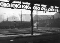 General view over the yard of the large Trafford Park shed, Manchester, in the sixties. Originally built as a 20-road straight dead-end shed it was used by locomotives of the MR, GNR and GCR and contained multiple coal stages, water tanks and turntables. The decaying shed, latterly coded 9E, was eventually closed in 1968 and demolished by 1975. A Freightliner container depot was later built on the site.  <br><br>[Jim Peebles //]