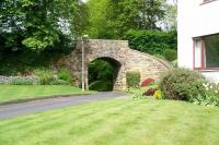 View north west along the trackbed towards the site of the former Peebles NB station which lay some 400m beyond the bridge. This particular overbridge, which once crossed the line to Galashiels, has now been incorporated into an attractively landscaped  housing development known as 'The Bridges'.<br><br>[John Furnevel 21/05/2010]