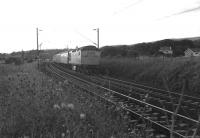 An Up West Highland Line service is nearing journey's end having just passed east through Cardross station on an July evening in 1973.<br>
<br><br>[John McIntyre /07/1973]