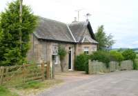 The old station house and surviving level crossing gates at Balgowan on 12 July 2007 looking north. Located midway along the former line between Crieff and Perth, Balgowan lost its passenger service in 1951. The site of the old station itself, on the opposite side of the crossing, is now occupied by housing. Note the 0-6-0 weathervane. <br><br>[John Furnevel 12/07/2007]