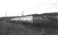 A Helensburgh Central - Airdrie service heads east away from Cardross station on an July evening in 1973 with a 6-car <I>'Blue train'</I>.<br>
<br><br>[John McIntyre /07/1973]