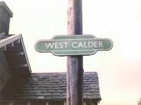 Twenty-six years ago, but a totem was already a rarity worthy of a <br>
photograph. Hardly surprising when the image was supposed to have been consigned to history 20 years before that. There was just the one left at West Calder in May 1984: I suspect the only reason it was still there was that on removal day they hadn't brought a ladder long enough.I believe the few remaining totems in Scotland were gone by the end of that year.  The building in the background is the now demolished eastbound waiting room [see image 20611].<br><br>[David Panton /05/1984]