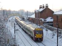 334025 departs Johnstone at the head of a six-car train on a bitterly cold 7th December 2010, a day when the temperature reached no higher than minus six, resulting in many failures.<br><br>[Graham Morgan 07/12/2010]