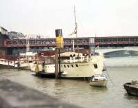 PS <I>Tattershall Castle</I> alongside Victoria Embankment on the Thames upstream from Charing Cross (Hungerford) Bridge in March 1976, in use as a floating pub/restuarant. Built in 1934 for the LNER, this was one of the last of a trio of paddle steamers used on the Humber Ferry. The others were PS Lincoln Castle and PS Wingfield Castle, now a floating exhibit at the Hartlepool Maritime Experience Museum. The vessel astern is the 'Hispaniola', another restaurant ship, originally the TSMV <I>Maid of Ashton</I>, one of the four Clyde 'Maids', now much modified.<br><br>[John McIntyre /03/1976]